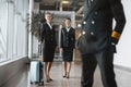 stewardesses looking at pilot at airport lobby Royalty Free Stock Photo