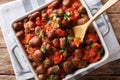 Stewed broad beans in tomato sauce with herbs and spices close-up. Horizontal top view Royalty Free Stock Photo