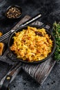 Stewed cabbage Bigos with mushrooms and sausages. Black background. Top view Royalty Free Stock Photo