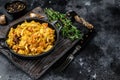 Stewed cabbage Bigos with mushrooms and sausages. Black background. Top view. Copy space