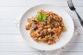 Stewed cabbage with mushrooms on white wooden background Royalty Free Stock Photo