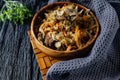 Stewed cabbage with oyster mushrooms and pork tongue with carrots and onions. Hot dish in a wooden plate on a wooden stand, next t Royalty Free Stock Photo