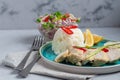 Stewed chicken breast in the oven with boiled white rice. Garnished with red chili peppers, green onion strips and lemon slices Royalty Free Stock Photo