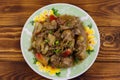 Stewed chicken liver with apple and onion on wooden table Royalty Free Stock Photo