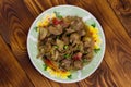 Stewed chicken liver with apple and onion on wooden table Royalty Free Stock Photo