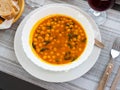 Stewed curried chickpeas with spinach on white plate