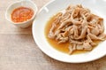 Stewed duck intestine in brown soy soup on plate dipping spicy sauce