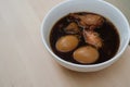 Stewed eggs or eggs and chicken with spices in brown sauce