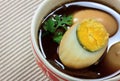 Stewed eggs or eggs and pork in brown sauce by Thai food .