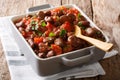 stewed hot broad beans with tomato sauce, garlic, onion and greens close-up. Horizontal Royalty Free Stock Photo