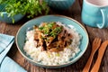 Stewed liver in a sauce with onion, carrot and parsley and boiled rice.