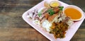 Stewed pork leg with rice, garlic, slices of boiled egg, pickle, Vegetable and sour sauce in pink dish Royalty Free Stock Photo