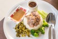 Stewed pork leg on rice on wooden table, asian food.