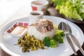 Stewed pork leg on rice on wooden table, asian food.