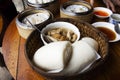 Stewed pork leg shank with mantou steamed chinese bun and dim sum or dumplings in basket of local restaurant cafe shop for thai Royalty Free Stock Photo