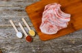 raw ingredients for stew. pork meat ,salt and fresh seasoning on old rustic cutting board