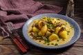 Stewed potatoes with meat gravy and scallions