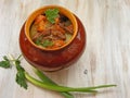 Stewed rabbit with vegetables Goulash in Copper Pot on shabby Wooden background, roasted beef meat with carrot, leek, onion in rou Royalty Free Stock Photo