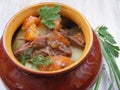 Stewed rabbit with vegetables, Venison Goulash in Copper Pot on Wooden Surface, roasted beef meat with carrot, leek, onion in roun