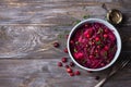 Stewed red cabbage with apples, cranberries, spices and greens on a wooden background Royalty Free Stock Photo