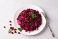 Stewed red cabbage with apples, cranberry sauce, cranberries, spices and greens on gray background