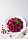 Stewed red cabbage with apples, cranberry sauce, cranberries, spices and greens on gray background