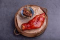 Stewed red pig\'s feet are in a bamboo container against a dark background Royalty Free Stock Photo