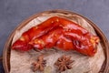 Stewed red pig\'s feet are in a bamboo container against a dark background Royalty Free Stock Photo