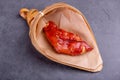 Stewed red pig's feet are in a bamboo container against a dark background Royalty Free Stock Photo