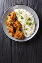 Stewed ribs in a spicy sauce served with white rice close-up. Vertical top view Royalty Free Stock Photo
