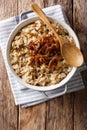 Stewed rice with lentils and fried onions close-up in a bowl. Vertical top view Royalty Free Stock Photo