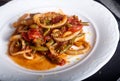 Stewed squid rings with tomato sauce and chilli Royalty Free Stock Photo