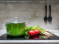 Stewpot with vegetables on induction cooker Royalty Free Stock Photo