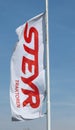 Steyr Tractor banner flag against blue sky outside local dealership. It is an austrian manufacturer of agriculture equipments