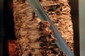 A stick of Arab shwarma in front of the grill