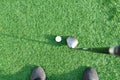 Stick with a ball on an artificial golf course Royalty Free Stock Photo