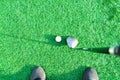 Stick with a ball on an artificial golf course Royalty Free Stock Photo