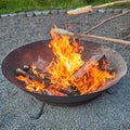 Stick bread or stick cake over a burning fire bowl Royalty Free Stock Photo