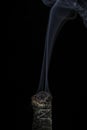 A Stick of Burning Buffalo Sage with Beautiful Flowing Smoke on a Black Background