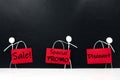Stick man figure holding red sale and Promotion signage poster. Black Friday concept. Royalty Free Stock Photo
