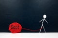 Stick man figure tied with a rope on a red rock with written word debt. Burden of paying debt concept