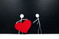 Stick man holding big red heart shape while giving to other people. Share love and kindness, give hope, helping others concept. Royalty Free Stock Photo