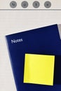 Stick note on blue notebook