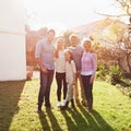 They stick together like glue. A full length portrait of a happy multi-generation family standing outdoors. Royalty Free Stock Photo