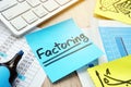 Stick with word factoring on a desk. Factor concept. Royalty Free Stock Photo