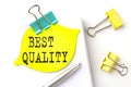 Sticker with BEST QUALITY text on notebooks on white background Royalty Free Stock Photo