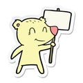 sticker of a cartoon bear holding sign Royalty Free Stock Photo
