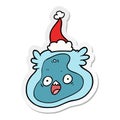 sticker cartoon of a germ wearing santa hat