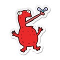 sticker of a cartoon poisonous frog catching fly Royalty Free Stock Photo