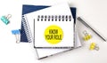 Sticker with KNOW YOUR ROLE text on notebooks on the white background Royalty Free Stock Photo